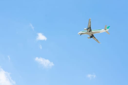 Image of Plane lands with blue sky and clouds