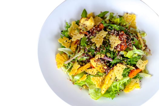 A salad with romaine lettuce cheese cracker and different seeds.