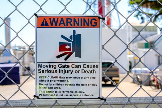 Warning Sign, Moving gate can cause serious injury or death message. Electric door sign.