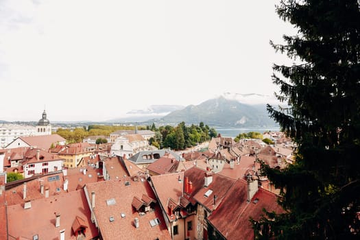 Annecy city top view, lake in the distance. Tile roofs, Cathedral. High quality photo