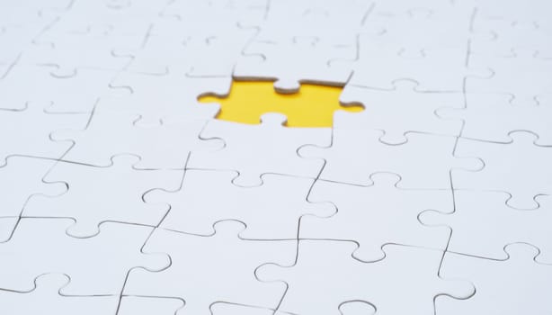 Empty white jigsaw puzzle with missing piece