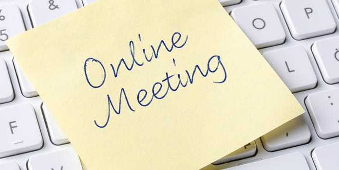 Sticky note on a keyboard - Online Meeting