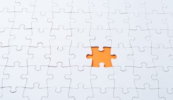 Empty white jigsaw puzzle with missing piece