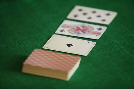deck of playing cards on a green gaming table