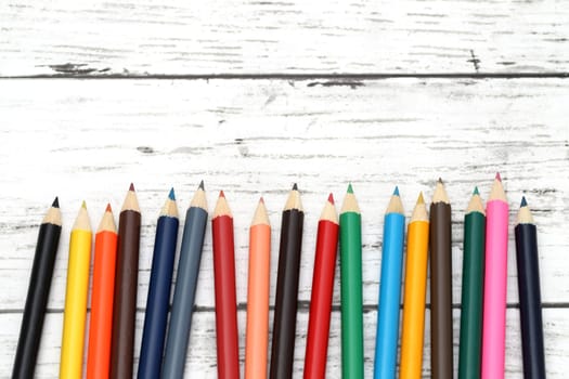 wooden colorful pencils on white wooden table
