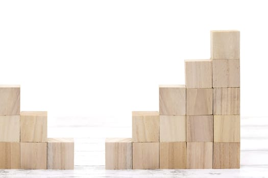 stairs of wooden toy blocks on white table
