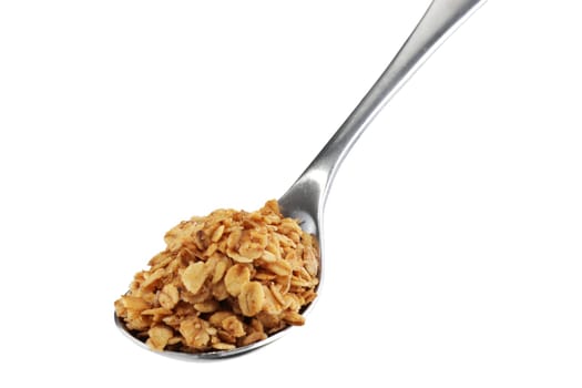 A stainless steel spoon inclined with granola oats
