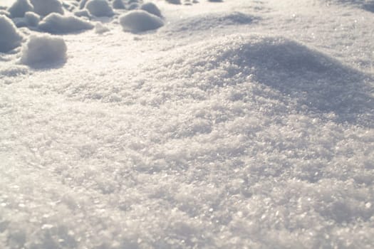 pure white snow sparkles on the sun close up, snowy surface