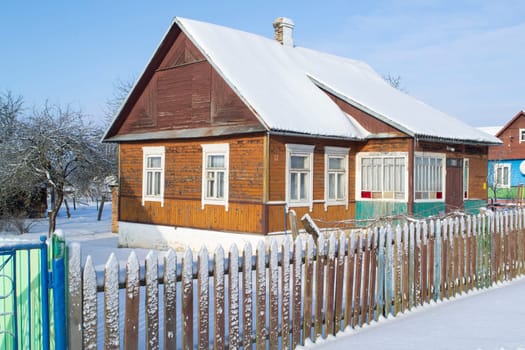 Old wooden house in village. Farmhouse in Belarus. View of rustic ethnic house in winter.