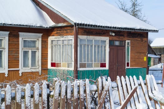 Colorful wooden old house in Belarus winter time, close up