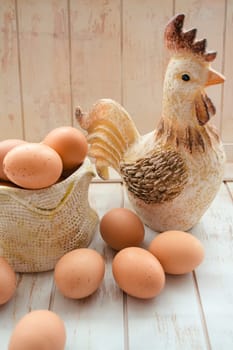 Composition of eggs and rooster toy. Concept of interior decoration for Easter. Vertical image