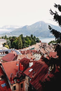 Annecy city top view, lake in the distance. Tile roofs, Cathedral. High quality photo