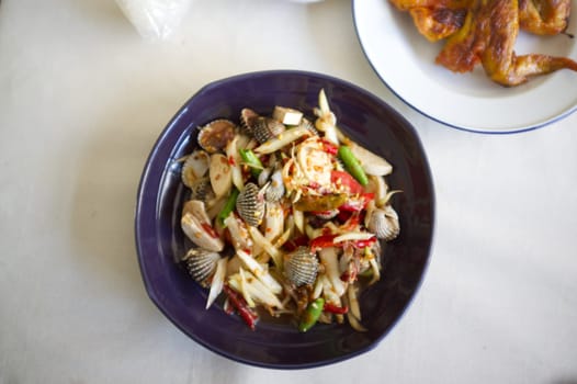Thai food , Papaya salad cockles in the plate