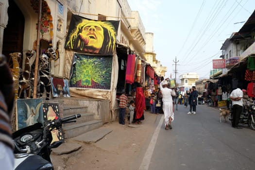 People walk around downtown in Pushkar, India. The city is one of the five sacred dhams for devout Hindus, in Pushkar, Rajasthan, India.