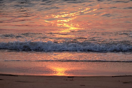 Wave rolling over the sands on Candolim Beach, North Goa, India