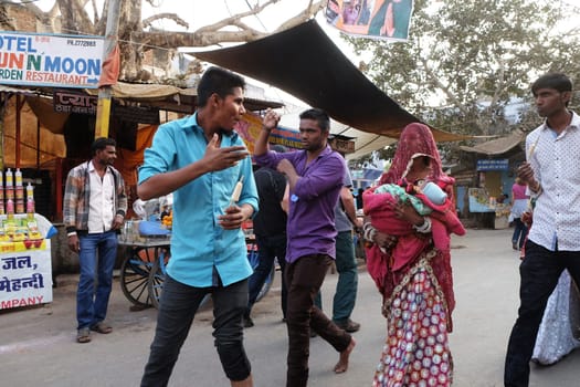 People walk around downtown in Pushkar, India. The city is one of the five sacred dhams for devout Hindus, in Pushkar, Rajasthan, India.