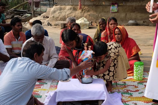 Faithful Catholics during an outdoor Mass in the village of Mitrapur, West Bengal, India