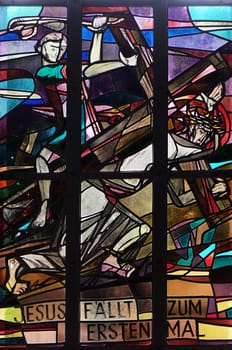 3rd Stations of the Cross, Jesus falls the first time, stained glass window in Saint Lawrence church in Kleinostheim, Germany