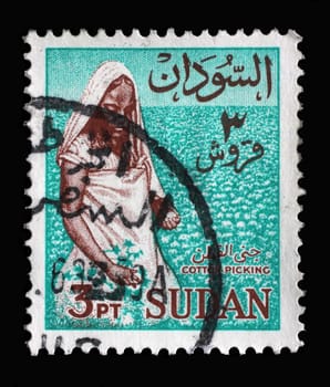 Stamp printed in the Sudan shows Woman picking cotton, circa 1962