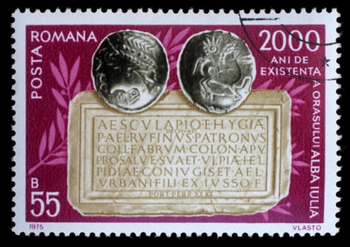 Stamp printed in Romania shows Coins and tablet, 2,000 Years City of Alba Julia issue, circa 1975.
