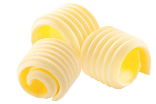 Butter curls rolled up, a group of three, isolated