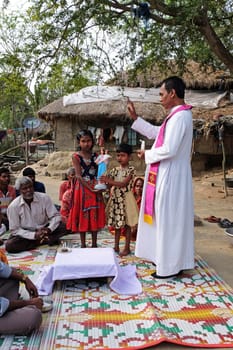 Faithful Catholics during an outdoor Mass in the village of Mitrapur, West Bengal, India