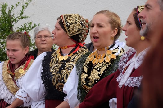 People sing and dance after the Mass on Thanksgiving day in Stitar, Croatia