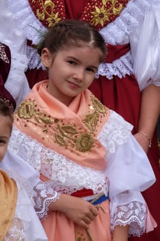 Girl dressed in folk costumes go to the church at the Mass on Thanksgiving day in Stitar, Croatia
