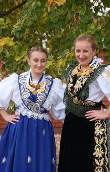 Women dressed in folk costumes go to the church at the Mass on Thanksgiving day in Stitar, Croatia