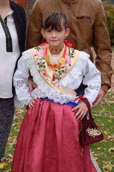 Girl dressed in folk costumes go to the church at the Mass on Thanksgiving day in Stitar, Croatia