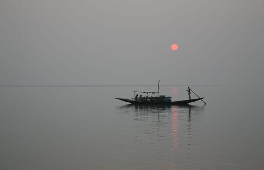 A stunning sunset looking over the holiest of rivers in India. Ganges delta in Sundarbans, West Bengal, India.