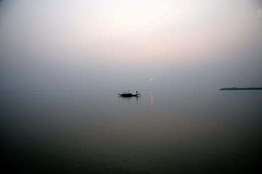 A stunning sunset looking over the holiest of rivers in India. Ganges delta in Sundarbans, West Bengal, India.