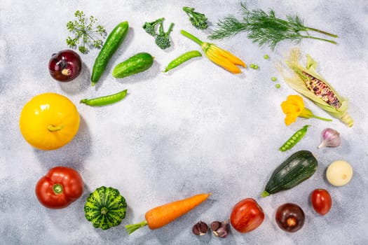 Fresh select seasonal vegetables on light textured backdrop, top view w/ copy space. Locavore movement, eat local, clean eating, farm fresh concept