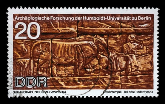 Stamp printed in GDR shows Sudanese Archaeological Excavations by Humboldt University Expedition, Part of the frieze Cattle, reproduce carvings unearthed at Lions Temple, Musawwarat, circa 1970
