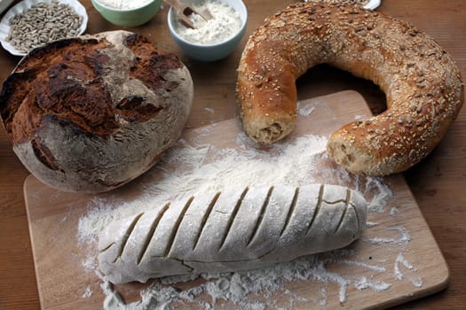 Baking bread. Dough on wooden table with flour