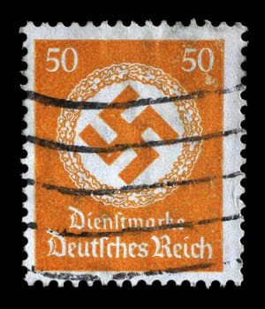 Stamp printed in Germany shows the Swastika in an oak wreath, circa 1942.