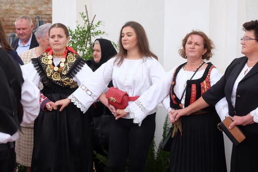 People sing and dance after the Mass on Thanksgiving day in Stitar, Croatia