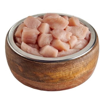 Bowl of delicious raw chicken chunks for your pet dog or cat to provide a healthy diet in a high angle view isolated on white