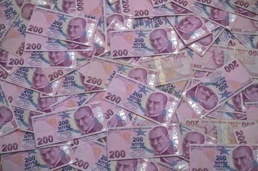 Stacks of Turkish banknotes create a vivid display, highlighting the intricate designs and notable figures on each bill.