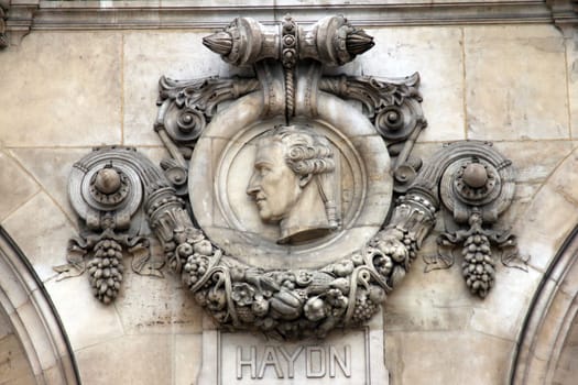 Architectural details of Opera National de Paris: Haydn Facade sculpture. Grand Opera (Garnier Palace) is famous neo-baroque building in Paris, France - UNESCO World Heritage Site.