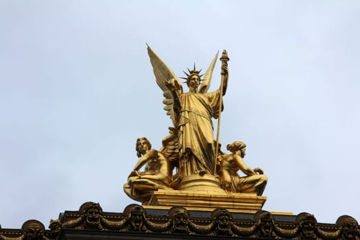 Golden statue of Angel on the top of the Garnier Opera in Paris, France (The Poetry by Charles Gumery)