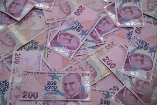 Turkish banknotes are spread out, displaying vibrant colors and intricate designs, reflecting the nation's economy.