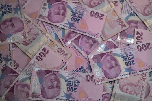 A vibrant collection of pink currency bills fills the view, showcasing intricate designs and various denominations.