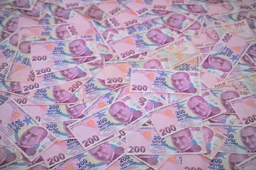 A vast collection of banknotes covers a flat surface, displaying their colorful designs and intricate details.