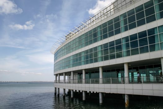 Lisbon, Portugal - September 17, 2006: Lower floors of Vasco da Gama tower (Expo '98 World's Fair venue), and bridge with the same name in background on sunny day.