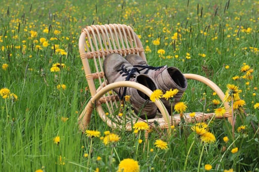 In spring,the mountaineering season began. Mountain boots on a rocking chair are waiting for use