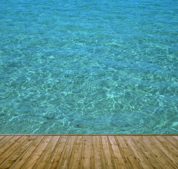 Wooden bathing jetty with clear blue water