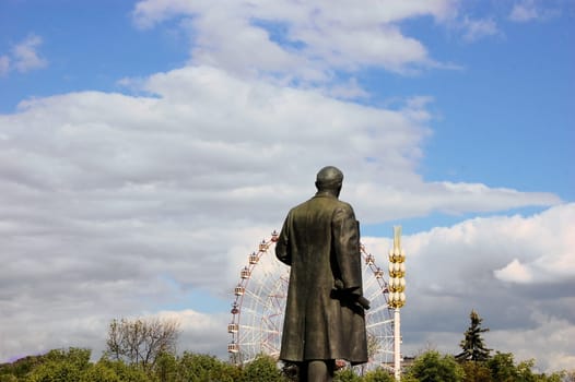 View of Ferris wheel and Lenin statue in front at All-Russian Exhibition Center in Moscow, Russia.