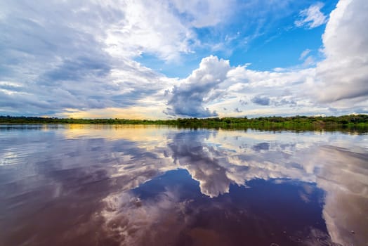 Dramatic sky reflected in the water of the Javari River in the Brazilian Amazon