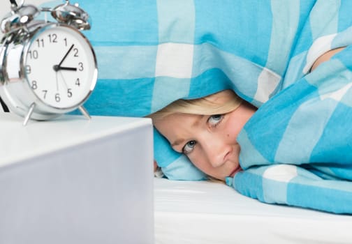 Woman lies sleepless under the duvet